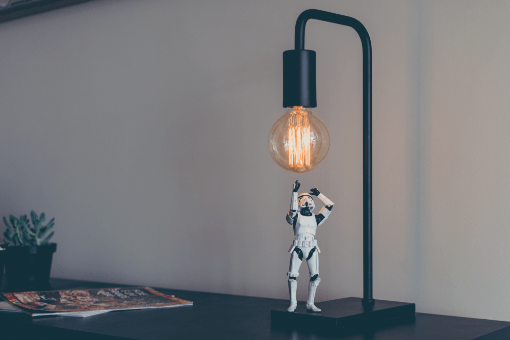 Figurine with a light bulb indicating creativity.