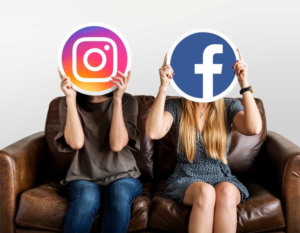 Two woman holding Instagram and Facebook logos